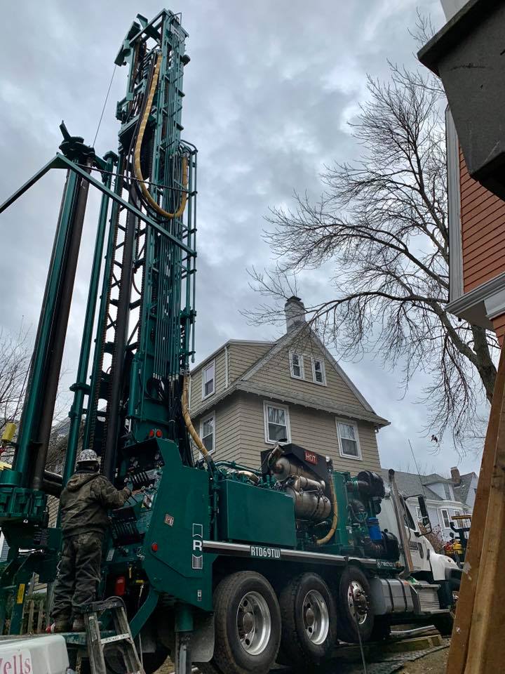 GDNE compact low-emission drill rig working in a tight residential backyard in Massachusetts