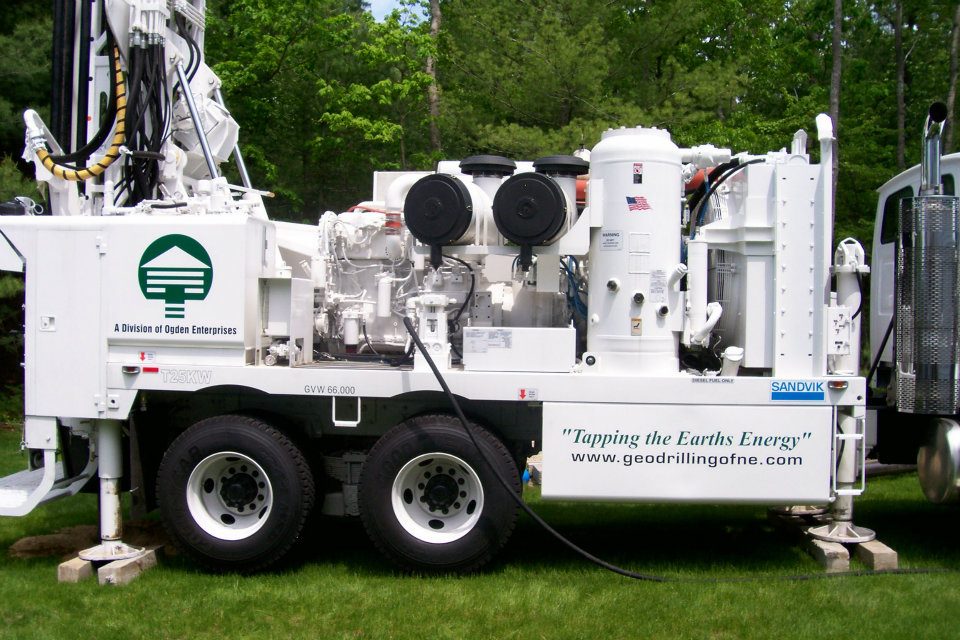 GDNE Ogden Wells rotary drilling rig installing vertical geothermal boreholes on a residential Massachusetts lawn