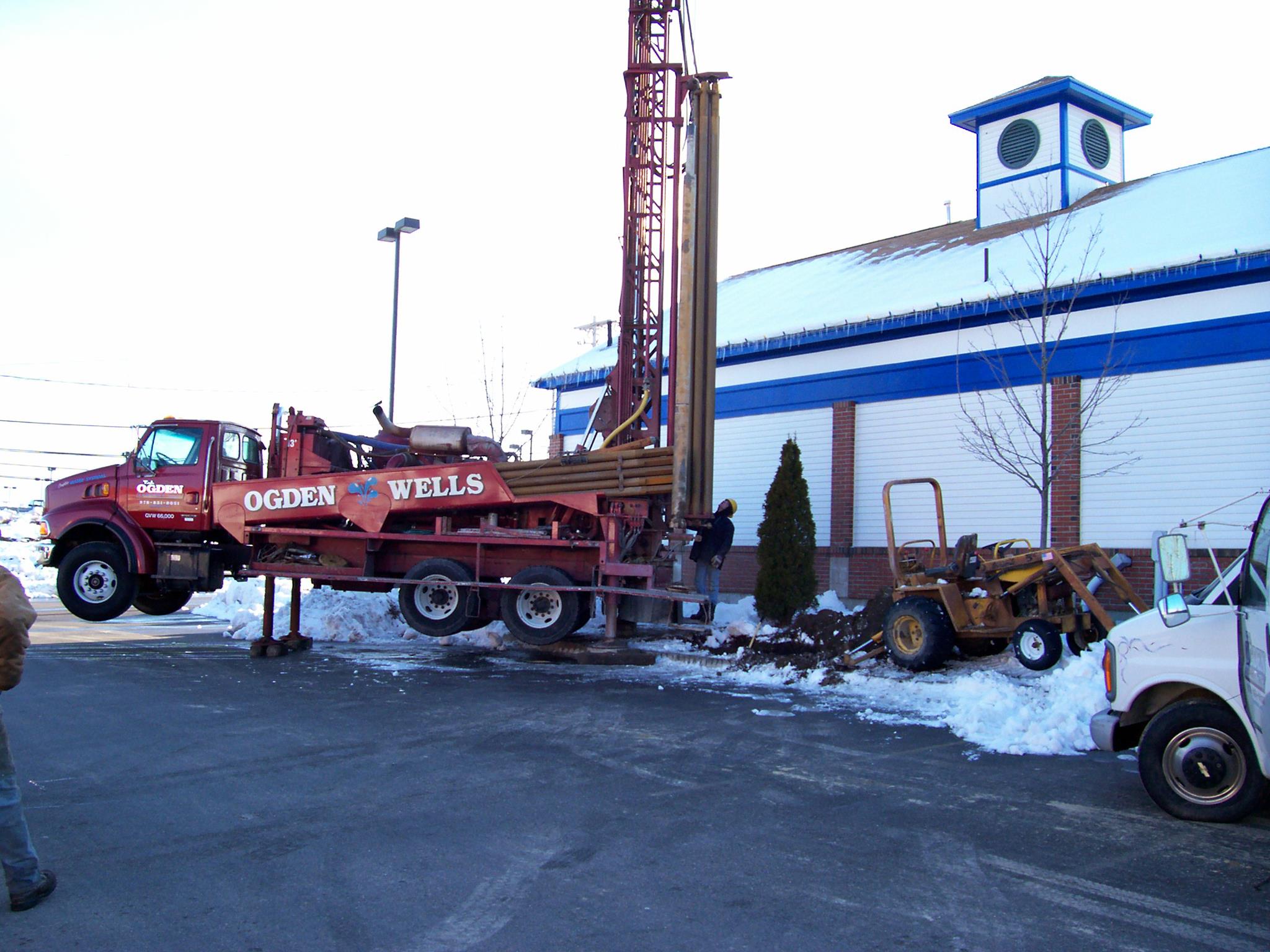 GDNE heavy rotary air hammer drill rig mast raised on New England site