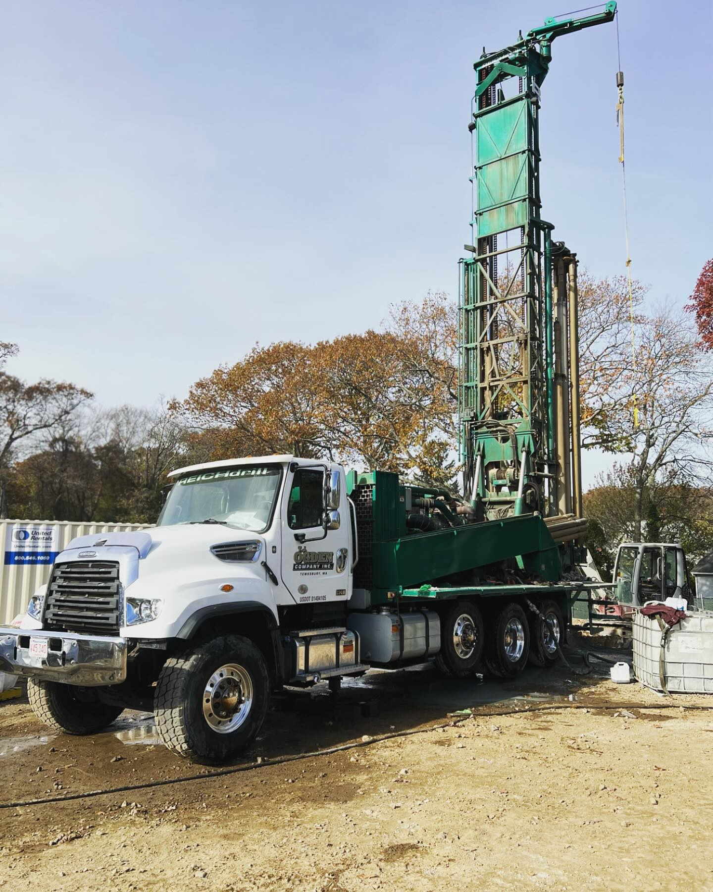 Rotary air hammer drill mast penetrating crystalline New England granite.